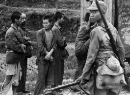 Conscripts being loaded onto transport, or Japanese prisoners being loaded. In China during WWII.