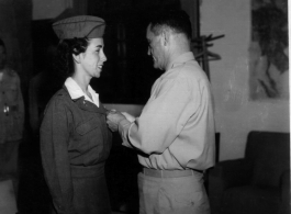 1st Lt. Addie Newland, an Army Nurse assigned to the Medical Air Evacuation Squadron, receives Air Medal from General. C. L. Chennault in the CBI during WWII.