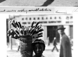 Street commerce in Kunming during wartime--selling small statues, and selling candied haws fruit.