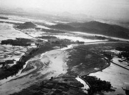 An aerial photograph during battle in the CBI. Note destroyed bridge in center of image.   (Images provided via Tony Strotman)