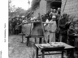 A funeral procession preparing to head out for burial ground in a Burma Road Chinese village during WWII.  In the CBI.   Photo by Syd Greenberg.