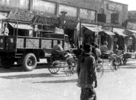 Street in India or Burma, with GIs riding rickshaws. During WWII.