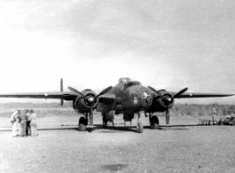 The "Skull & Wings" insignia on plane's side near the nose indicates this parked B-25J Mitchell is assigned to 490th Bomb Squadron, 341st Bomb Group.  The 490th had stayed in India, attached to Tenth Air Force, when 341st BG moved from to China in January 1944. With aerial combat finished in Burma, the 490th BS (attached to 312 Fighter Wing) moved in late April 1945 to Hanzhong (Han-chung), southwestern Shaanxi sheng (province), central China.  Images from Frank A. Bond.  (Additional information courtesy of