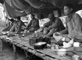 Nationalist soldiers convalesce on a bamboo platform covered in mosquito netting during WWII.