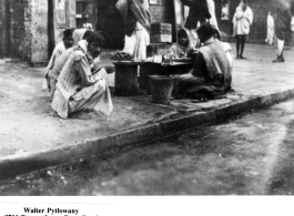 People selling something on the sidewalk in India, during WWII.  Photo from Walter Pytlowany. 