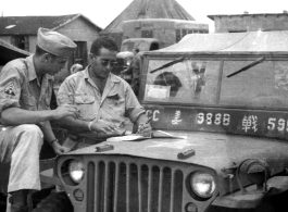 GIs strategize over the hood of a jeep in the CBI.  Photo from Paul Jones.