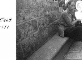 A bound-foot woman at Flower Circle, Kunming, during WWII.