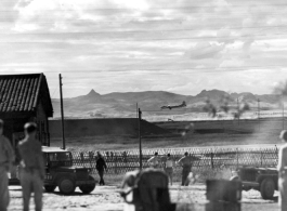 Everything stops as a Boeing B-29 Superfortress eases down to a runway in the CBI, probably at a base in Yunnan province. During WWII.