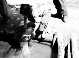 Local people in China: Woman washes some kind of produce in a water channel, during WWII.  From the collection of Eugene T. Wozniak.