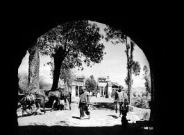 People as seen through a large town gate in Yunnan province, China, during WWII.