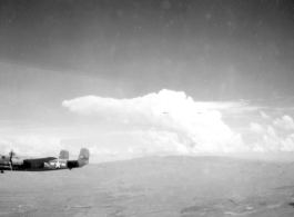 B-25 Mitchell bomber #439 in flight in the CBI, in the area of southern China, Indochina, or Burma.