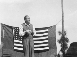 Pat O'Brien's USO troupe performs at an American airbase in China in October 1944--Here  Pat O'Brien perform at the microphone.