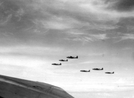 B-25 Mitchell bombers in flight in the CBI, in the area of southern China, Indochina, or Burma.  This image itself is probably taken from within a B-25, from the machine gun turret in the top of the fuselage.