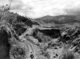 An American serviceman walking alone in the countryside in Yunnan province, China, carbine in hand. During WWII.