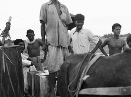 Local men with a mule-drawn train cart in India during WWII.    From the collection of David Firman, 61st Air Service Group.