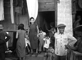 A Chinese women in the midst of daily life during war-time, in Yunnan province, China, most likely around the Luliang air base area.