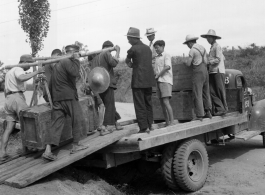 Moving supplies by truck and hard human labor in China during WWII.  From the collection of Hal Geer.