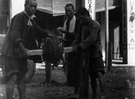 Putting down barbed wire in the fall of 1944 in Liuzhou. Notice the English "United Artist Studio" in the back--after the Japanese retreat from Liuzhou, only those pillars stood.