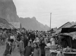 Bustling street scene of Chinese civilians and Nationalist soldiers not far from the south side of the floating bridge at Liuzhou, near the American air base, around the time of the evacuation of fall 1944.