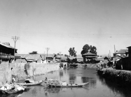 A canal near Kunming, China, during WWII, with boats.  From the collection of Hal Geer.