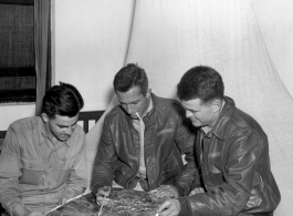 American flyers look over aerial image in the CBI during WWII.