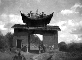 Three American servicemen strolling the countryside near Yangkai, Yunnan, China.  A local boy rides a cow or oxen in front.  Walter S. Polchlopek, Corporal, was lost on May 20, 1944, over the sea near the south east coast of China, after a B-24 mission to strike Japanese shipping.