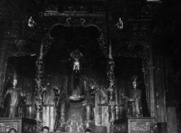 GIs and Chinese man inside a temple in China, probably at Confucian or Daoist temple. During WWII.