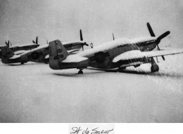 Several P-51s in a row after snowfall at a base in the CBI during WWII, the closest with tail #410788.