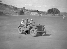 Chinese soldiers drive American jeep in northern China during WWII.