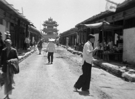 A drum or bell tower at the center crossroads of a squared, walled town in northern China, during WWII.