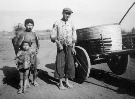 Rural farm people with their donkey cart. At the north end of the field, Yangkai, Spring 1944. During WWII.  From the collection of Frank Bates