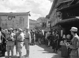 Market At Luliang, China, not far from American base, during WWII. Note the Nationalist propaganda on the facing wall.