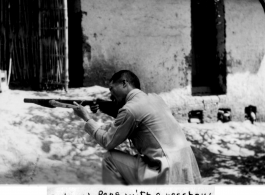 Colonel Peng, a Nationalist officer, trying out native crossbow. During WWII, in SW China.