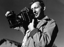 Eugene T. Wozniak, combat photographer for the 491st Bomb Squadron, with a Speed Graphic camera in Yunnan, China, during WWII.