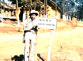 GI stands in front of sign of "WASC Yangkai Hostel" in WWII.