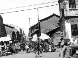 Market crowded with local people in in Kunming city, Yunnan province, China. During WWII.