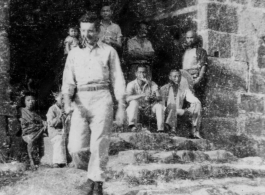 GI walking from gate in city wall in SW China, during WWII.