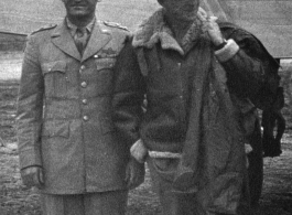 Chennault and Stilwell pose together in front of wing of transport airplane in Yunnan, China, during WWII.