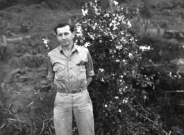 Eugene Wozniak poses among pines at Yangkai air base during WWII.