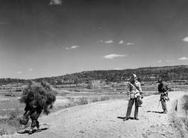 An unknown American photographer and a language interpreter take a stroll about in Yunnan, China, during WWII.