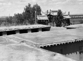 Flat mud roofs and ceremonial arch in northern China. 