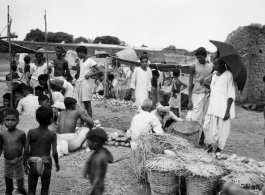 Busy market scene.  Scenes in India witnessed by American GIs during WWII. For many Americans of that era, with their limited experience traveling, the everyday sights and sounds overseas were new, intriguing, and photo worthy.