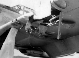 Damage to the forward edge of a wing of a P-51 fighter plane in the CBI during WWII.