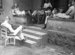 GIs resting at barracks area, likely at Yangkai, during WWII.  Smiley on right.