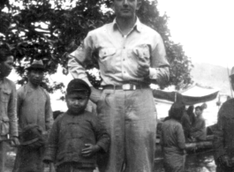 Douglas J. Runk poses with local kids and soldiers in SW China during WWII.