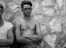 GIs of the 7th Bombardment Group leaning against a rock wall in China, during WWII, August 15, 1942.  Left is A. L. Cogwell, right is C. M. DeLeeuw.