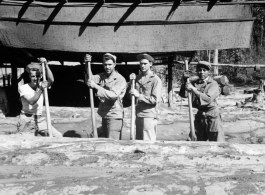 Wranging logs towards saw with cant hooks at a lumber mill of the 797th Engineer Forestry Company in Burma.  During WWII.