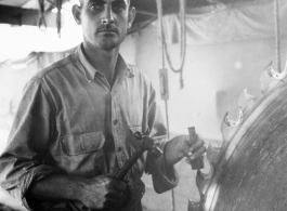 GI of the 797th Engineer Forestry Company in Burma, fixing saw blade in mill.  During WWII.