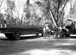 GIs load cut lumber at saw mill in Burma for transport to sites of bridge building.  During WWII.  797th Engineer Forestry Company.