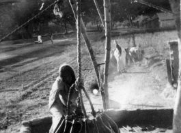 Local people in Burma near the 797th Engineer Forestry Company--A woman gets water in Burma.  During WWII.